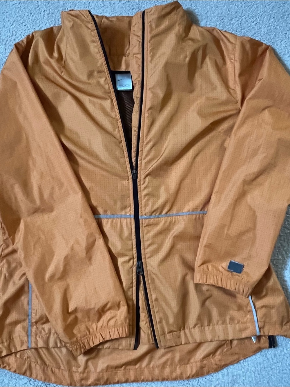 Nike Women’s Orange Lightweight Windbreaker Jacket with reflective contrast